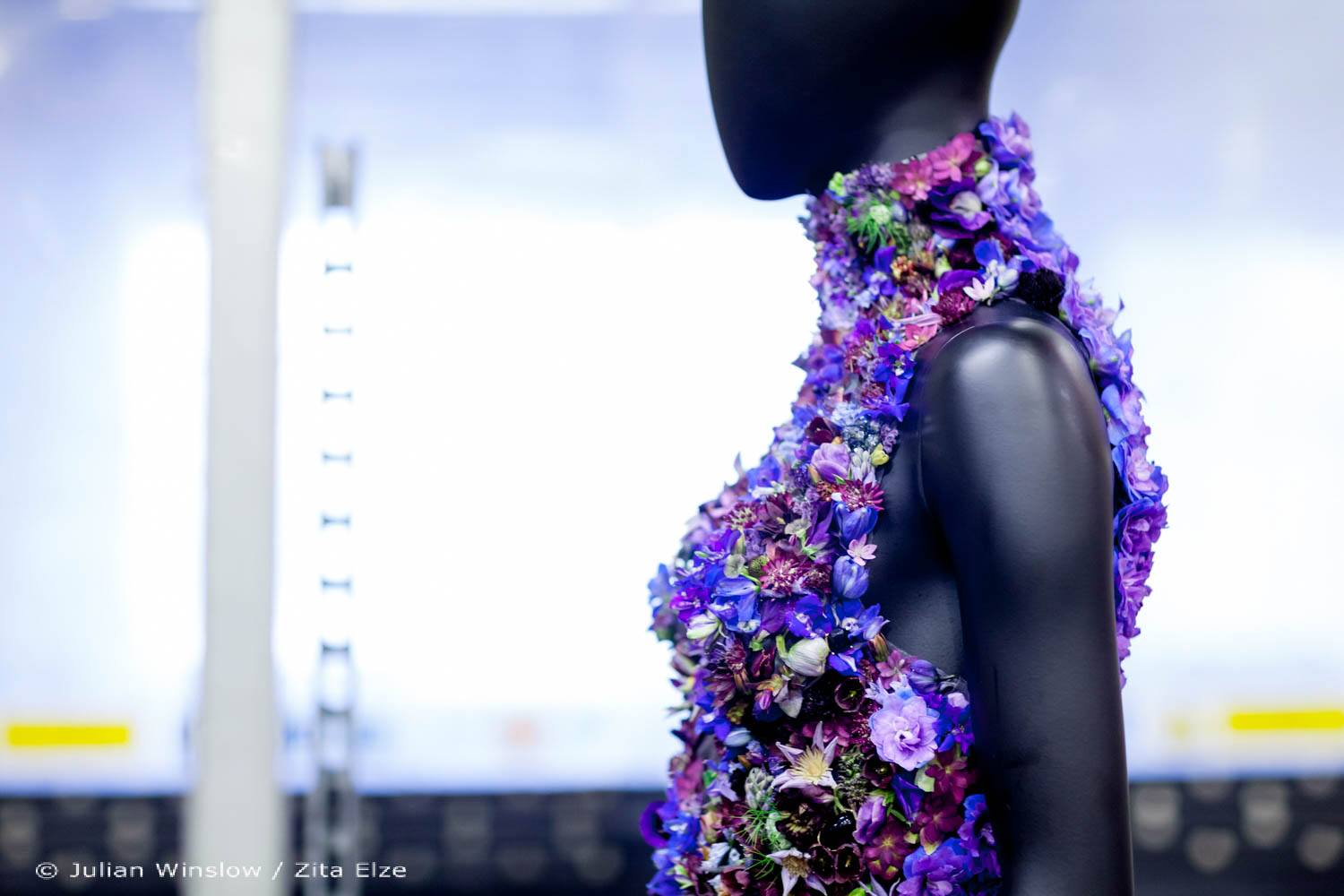 detail of the top of a gown realised with blue and violet flowers