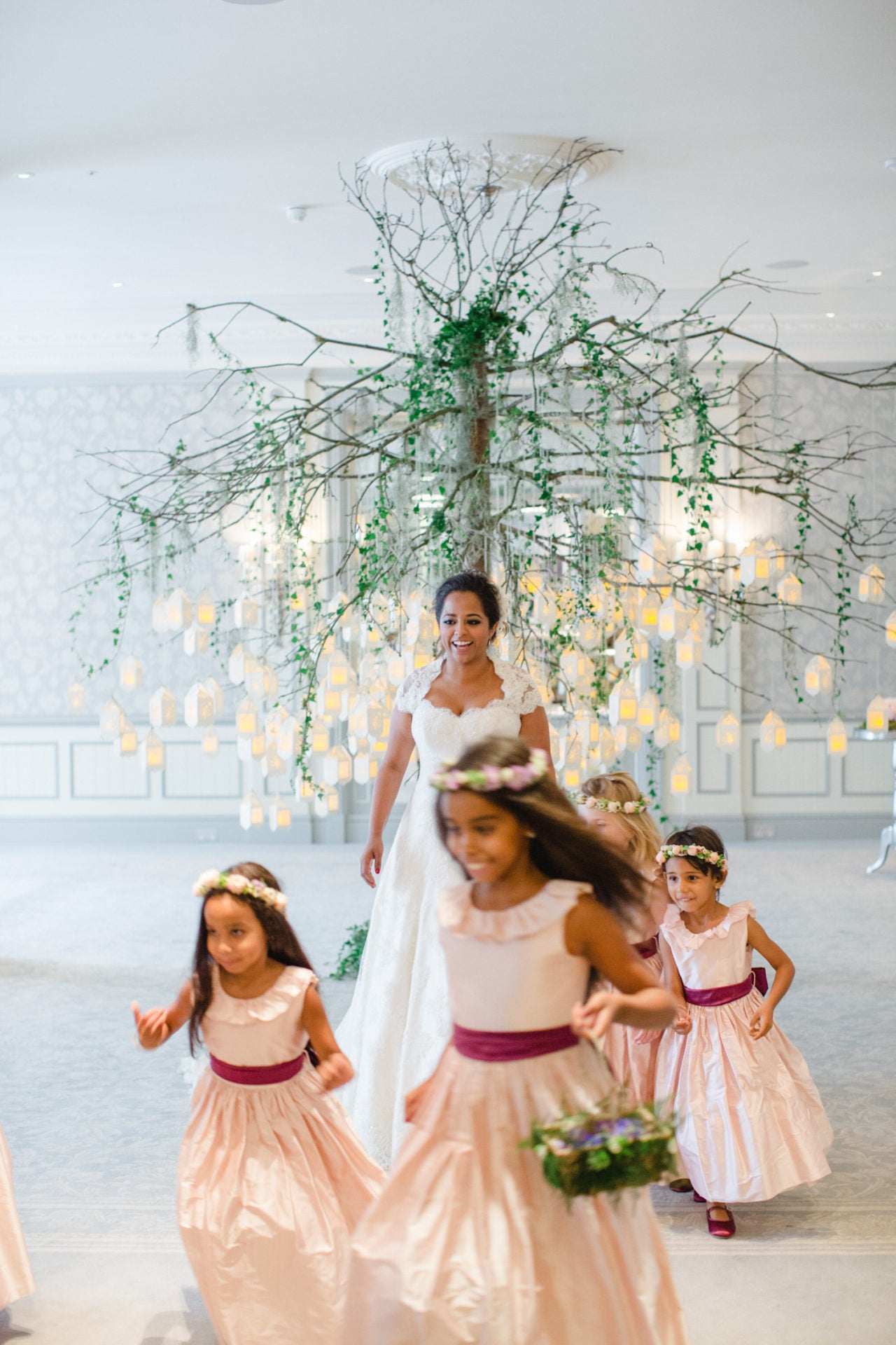 Bride with kids bridesmaids and a floral setting in the background