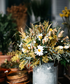 Flower bouquet with daises and yellow flowers in an aluminium basket