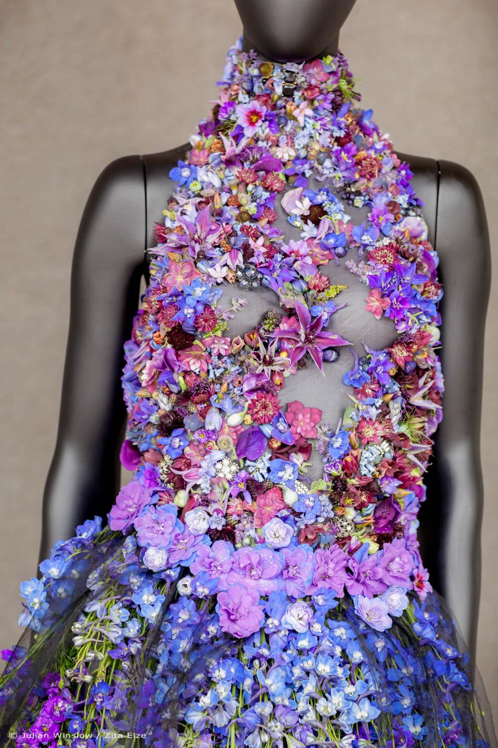detail of the top of a gown realised with blue and violet flowers