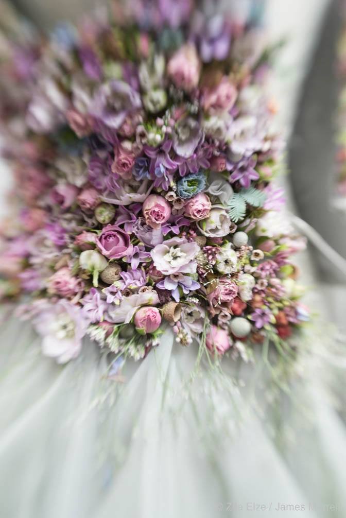 detail of a dress adorned with pink and lilac flowers