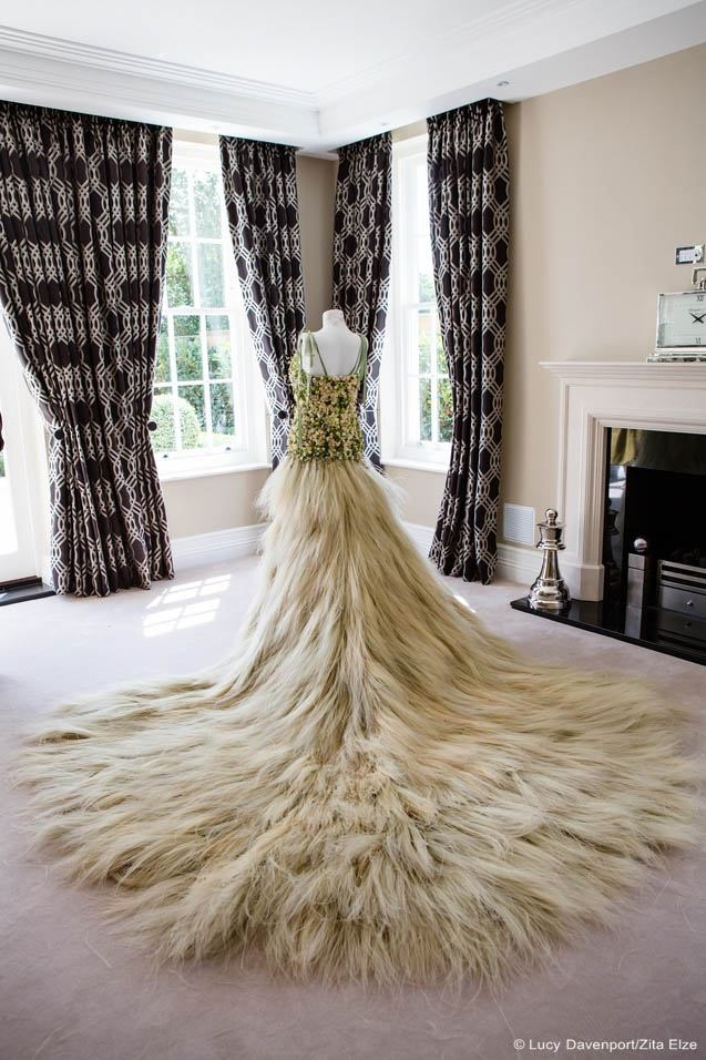 gown made of flowers and natural element seen from behind in the middle of a room