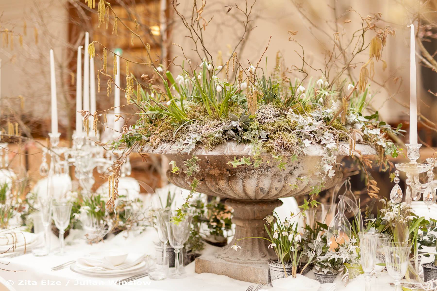detail of set up of a dining table with flowers and a centrepiece