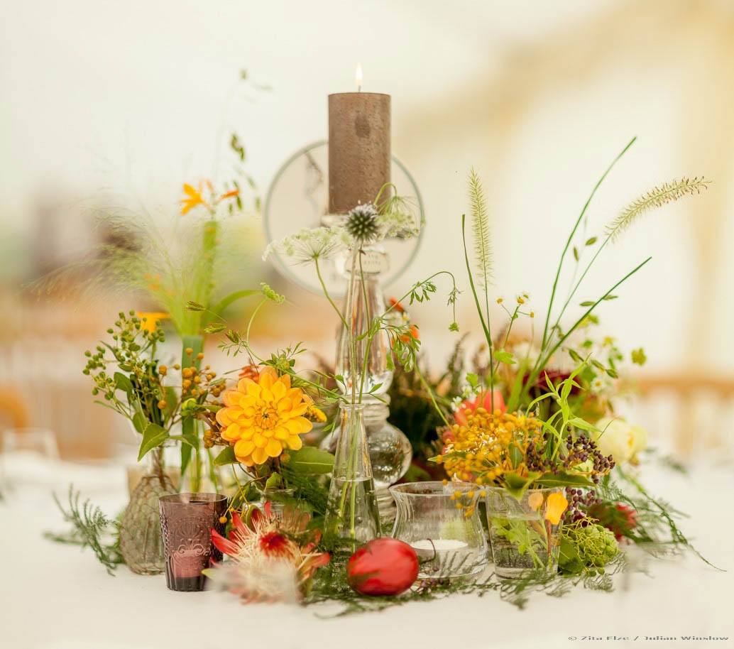 Floral centrepiece on yellow, red and green tones.